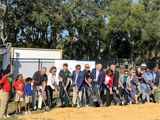 dignitaries shoveling dirt to break ground for new Boys & Girls Club facility