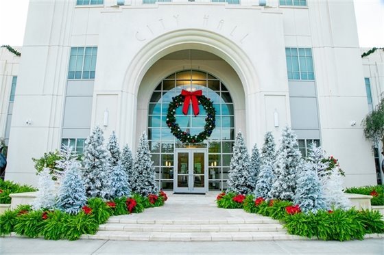 front of winter garden city hall with christmas trees on both sides of entrance 