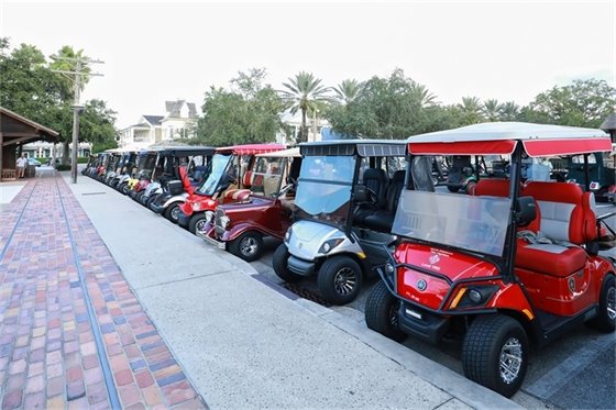 row of golf carts in a parking lot