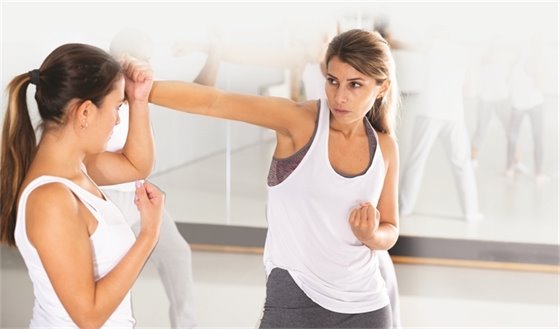 two women practicing self defense moves
