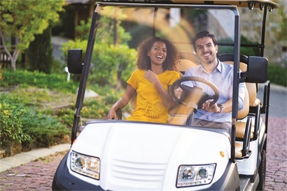 Two People Riding Golf Cart