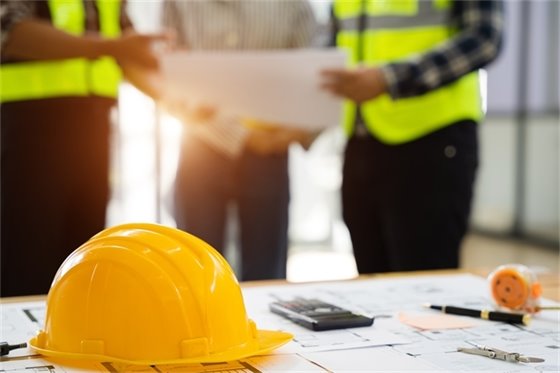 3 construction workers going over plans